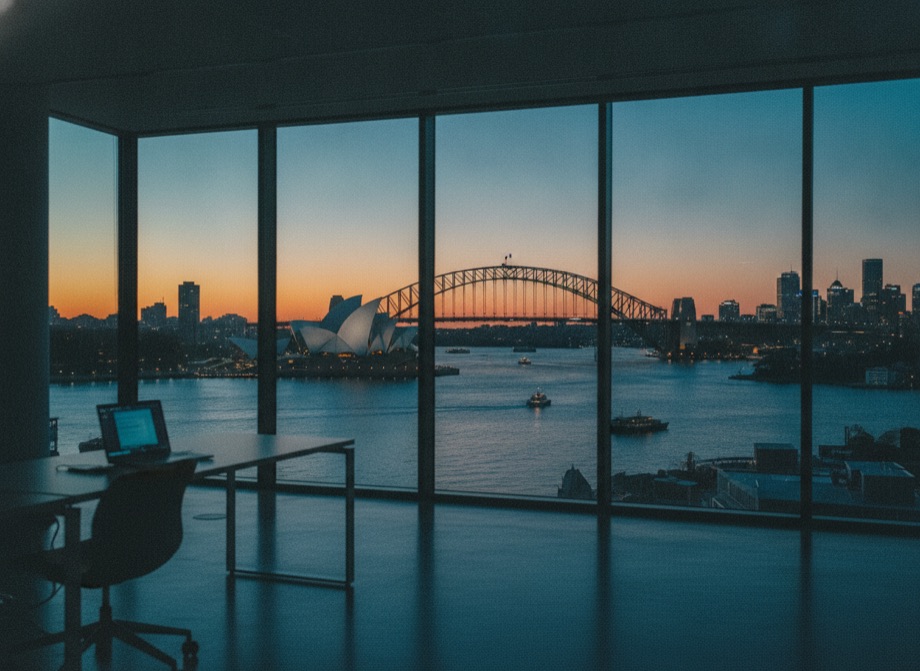 Sydney skyline and harbour at dusk from an office window
